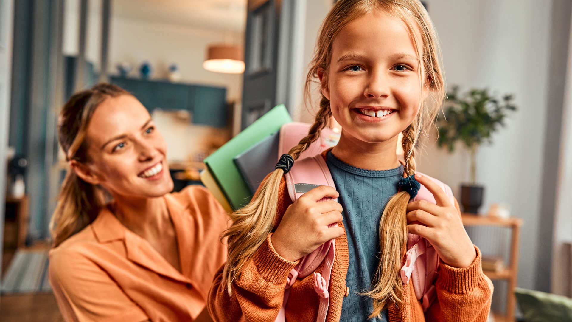 Young girl smiling in front of her mother