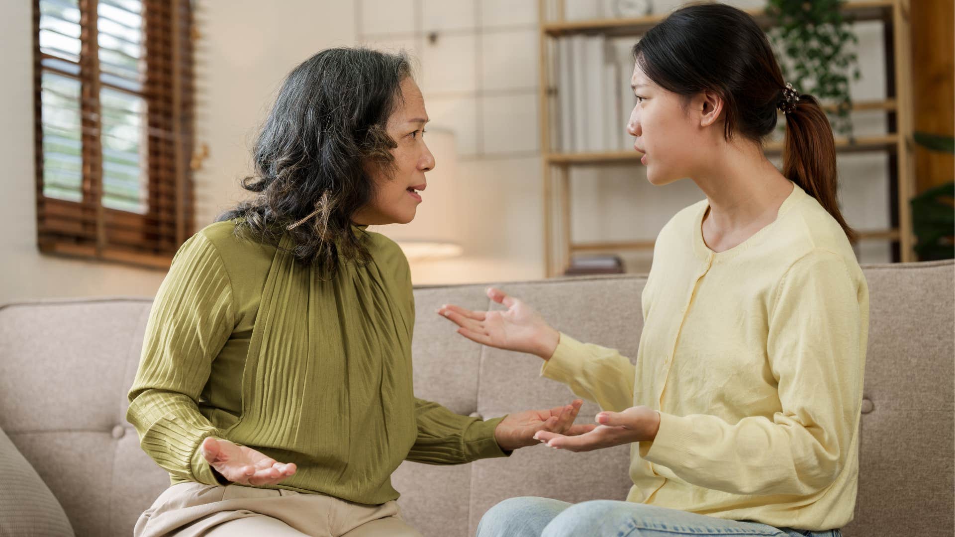 Adult woman talking to her upset mother.