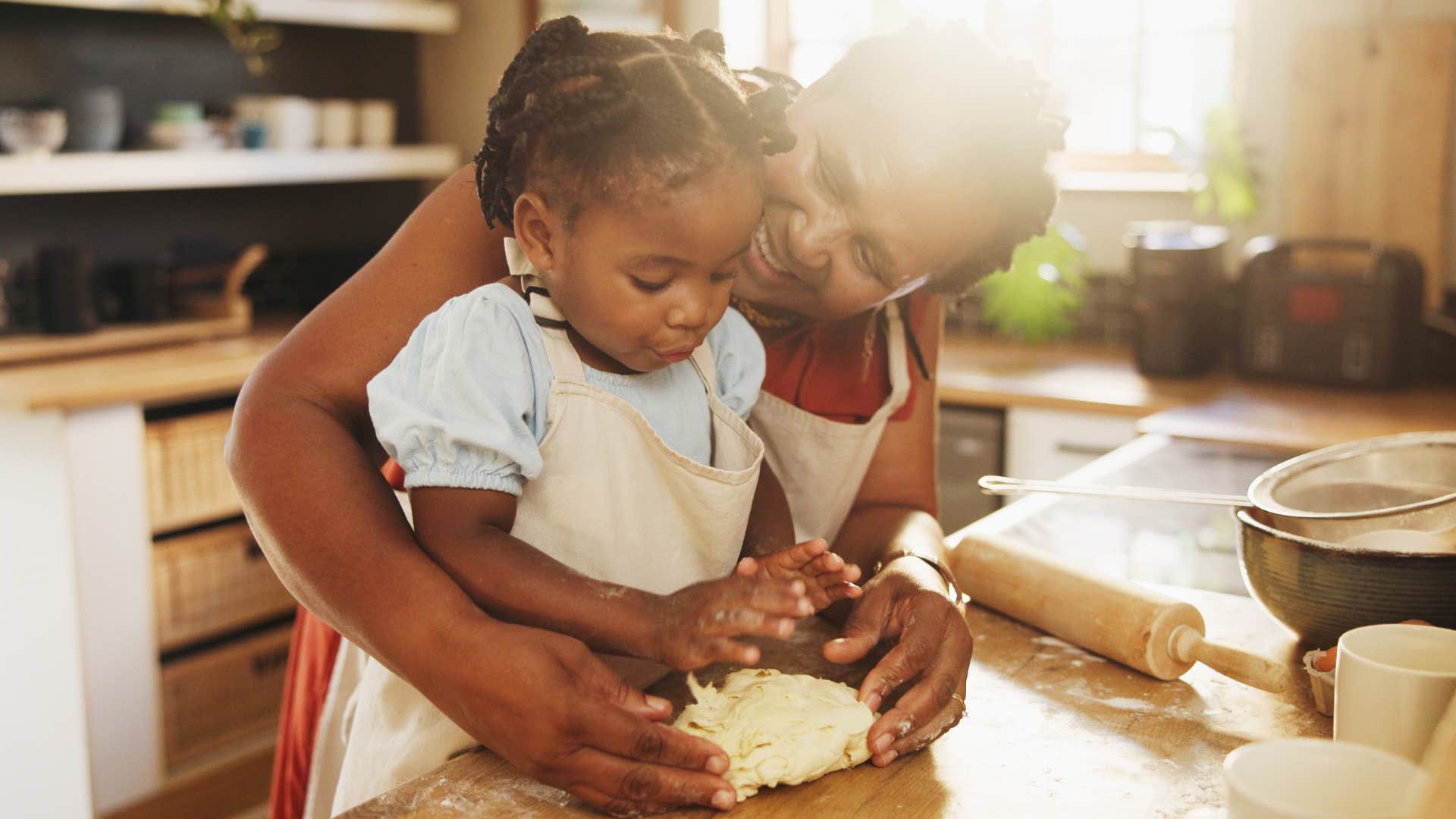 Grandmother smiling and baking with a young girl