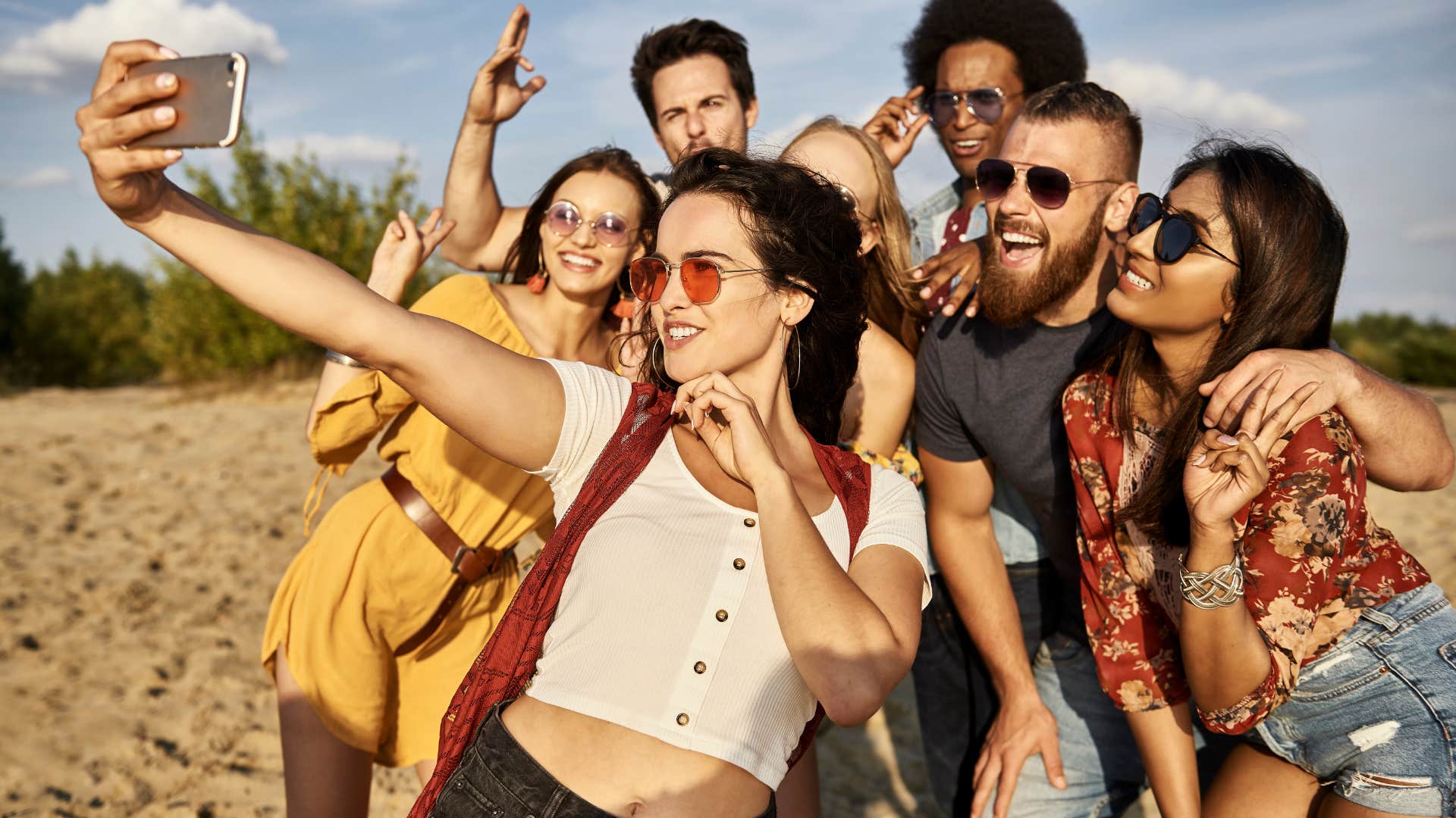 Group of friends taking a selfie at the beach