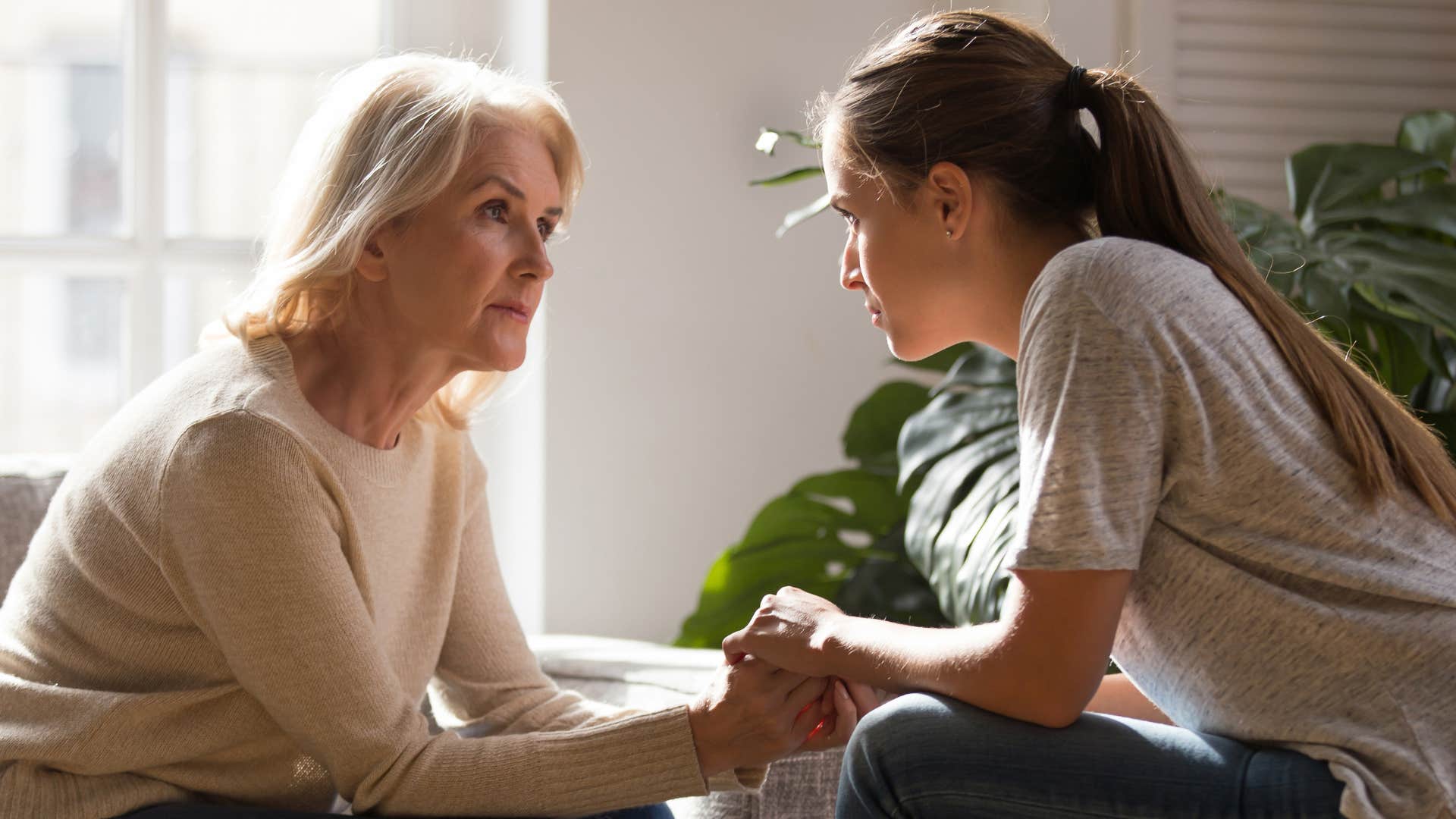 Woman talking to her mother at home.