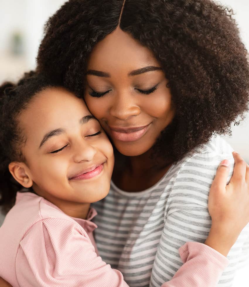 Grateful mother hugs smiling child