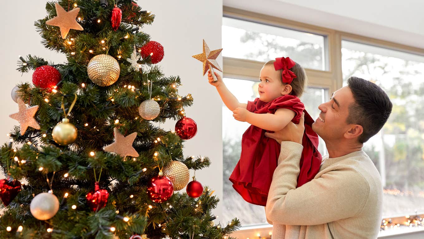 Dad and small child decorating for Christmas