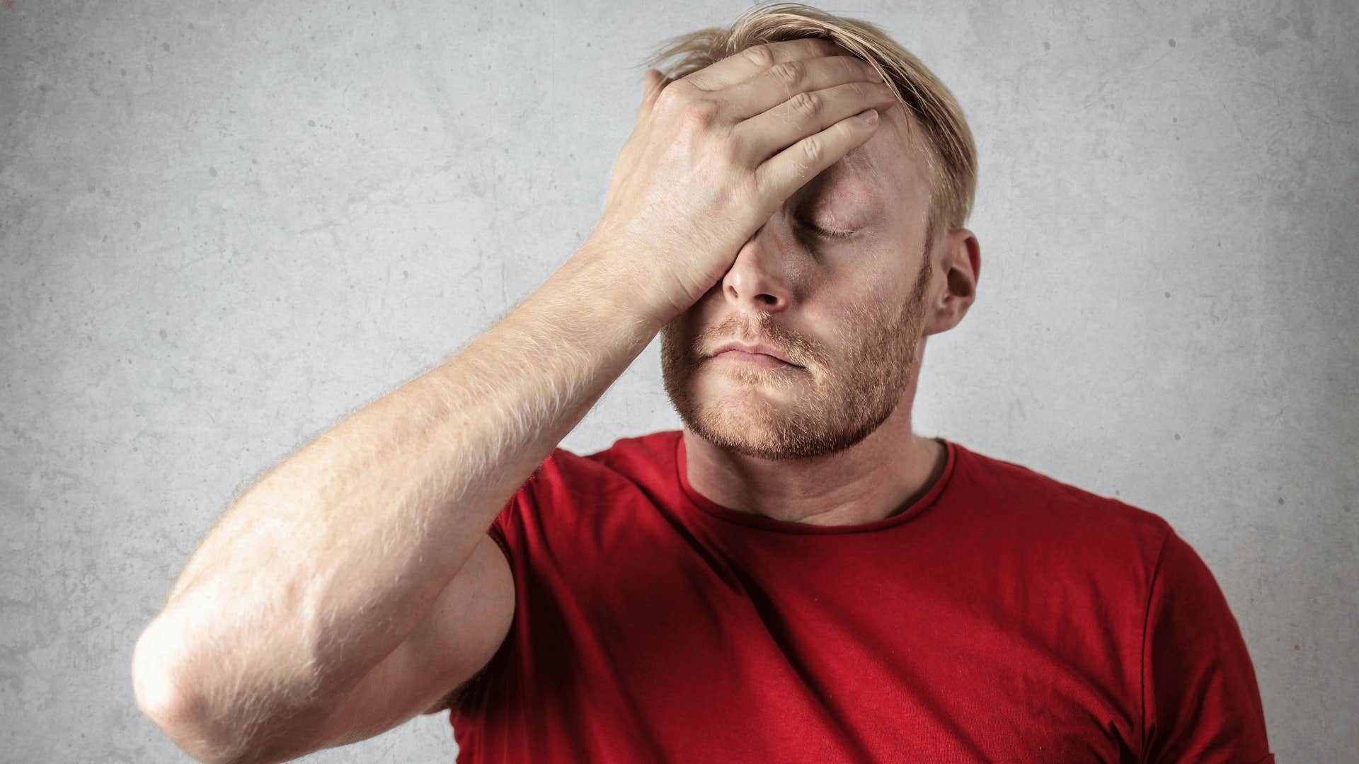 upset man with his hand on face