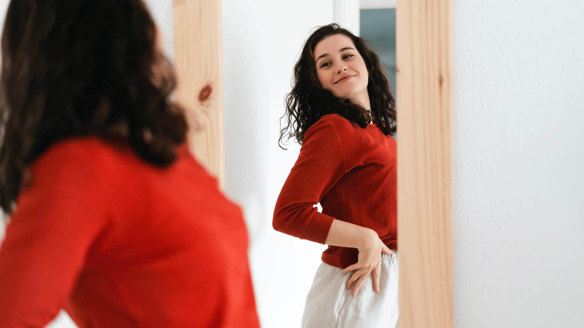 woman looking in mirror