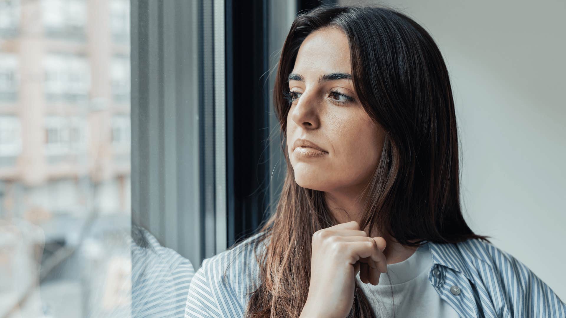 woman looking out window