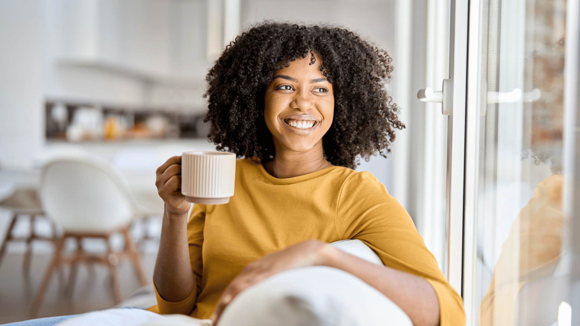 woman drinking coffee and smiling