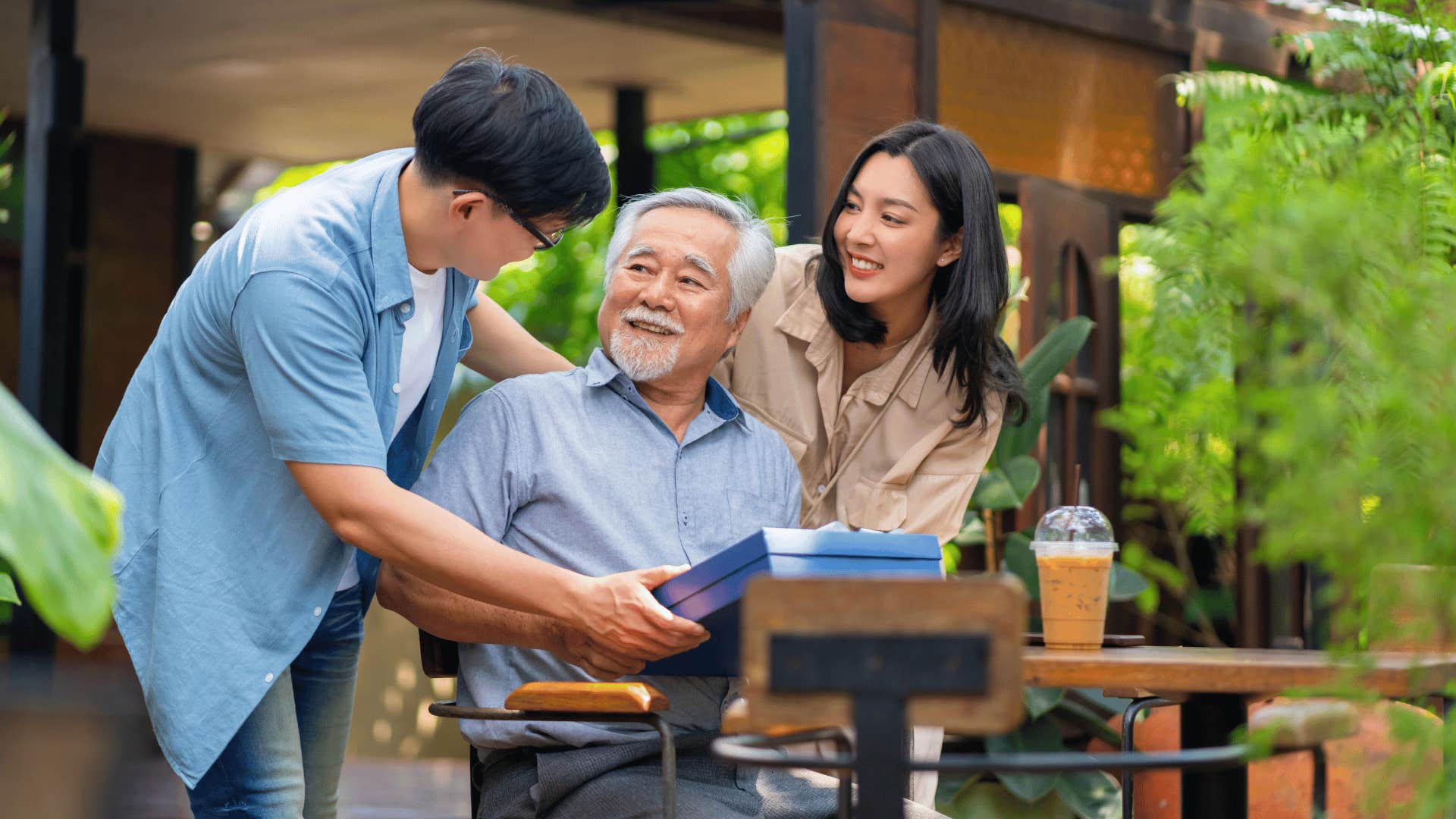 young man giving older man gift