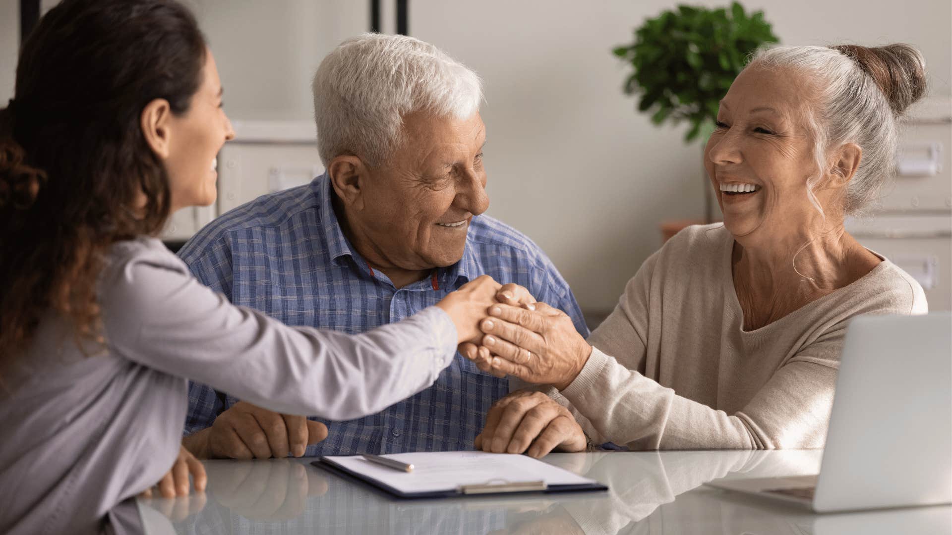 younger woman sitting with older couple