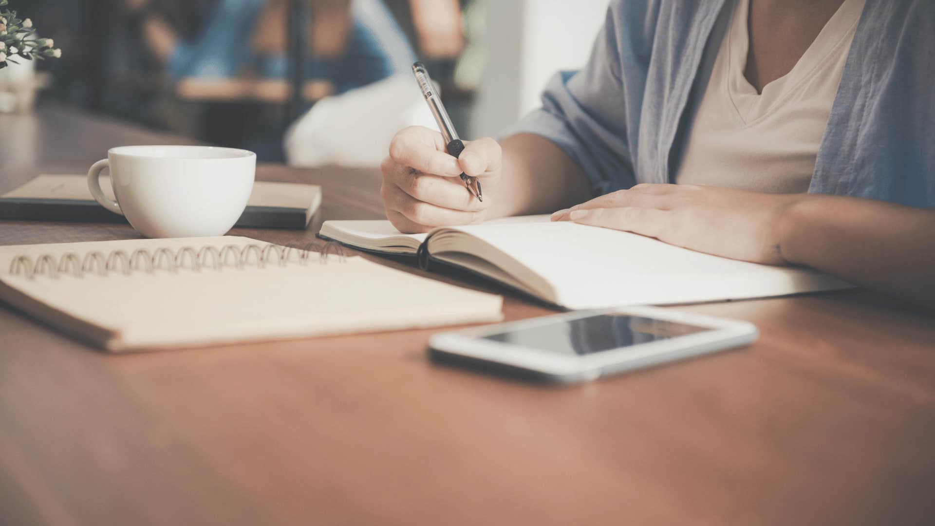 person writing in a journal