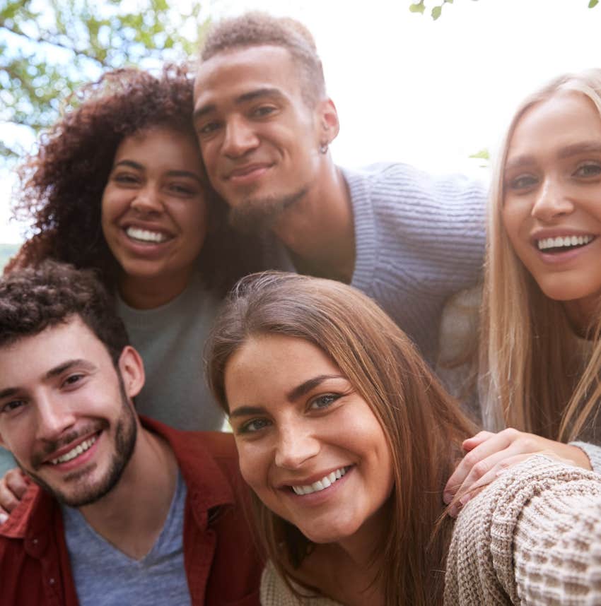 Group of people smile for a selfie while networking