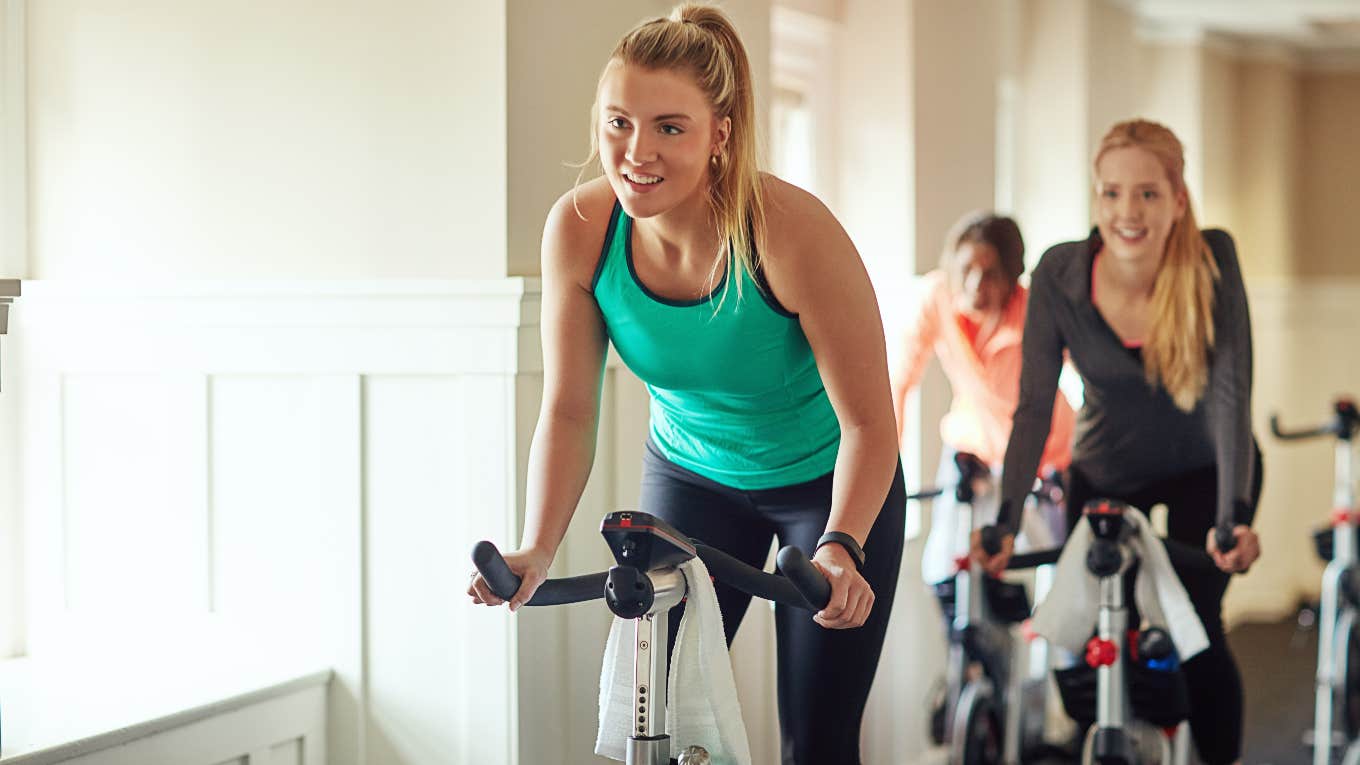 group of women using exercise bikes