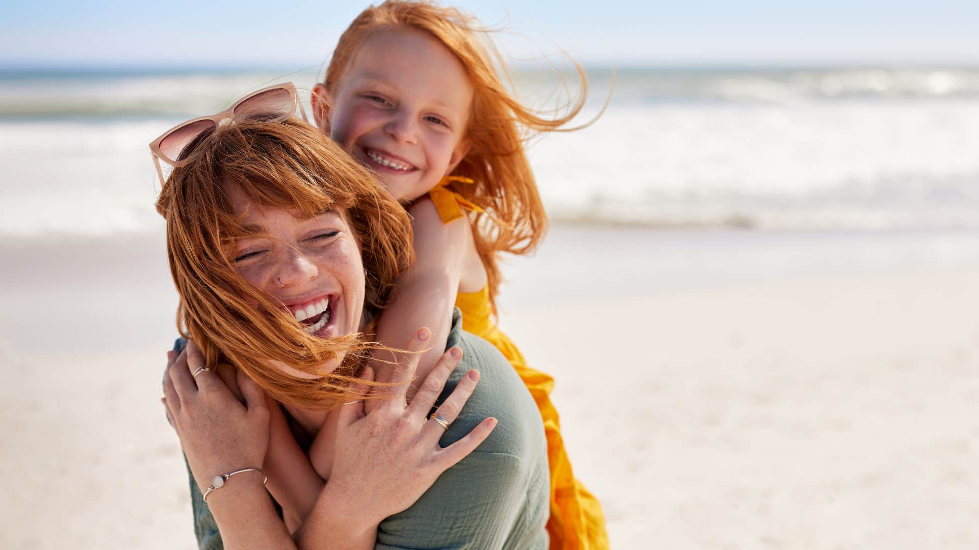 Woman smiling and hugging her daughter.