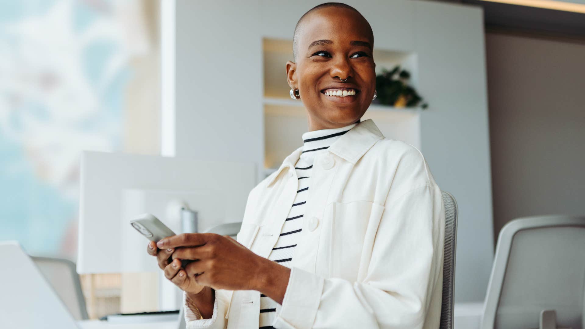 Woman smiling at her desk at work.