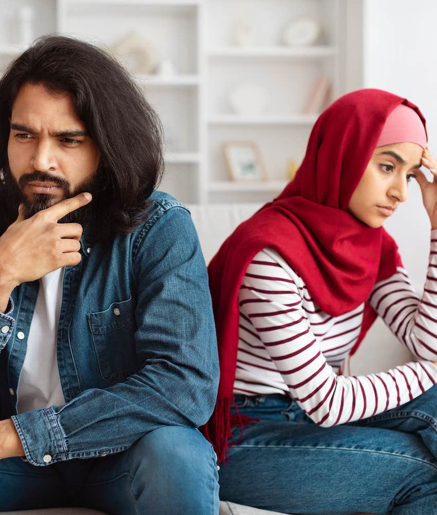 Couple sits back to back while the perceptive woman feels misunderstood