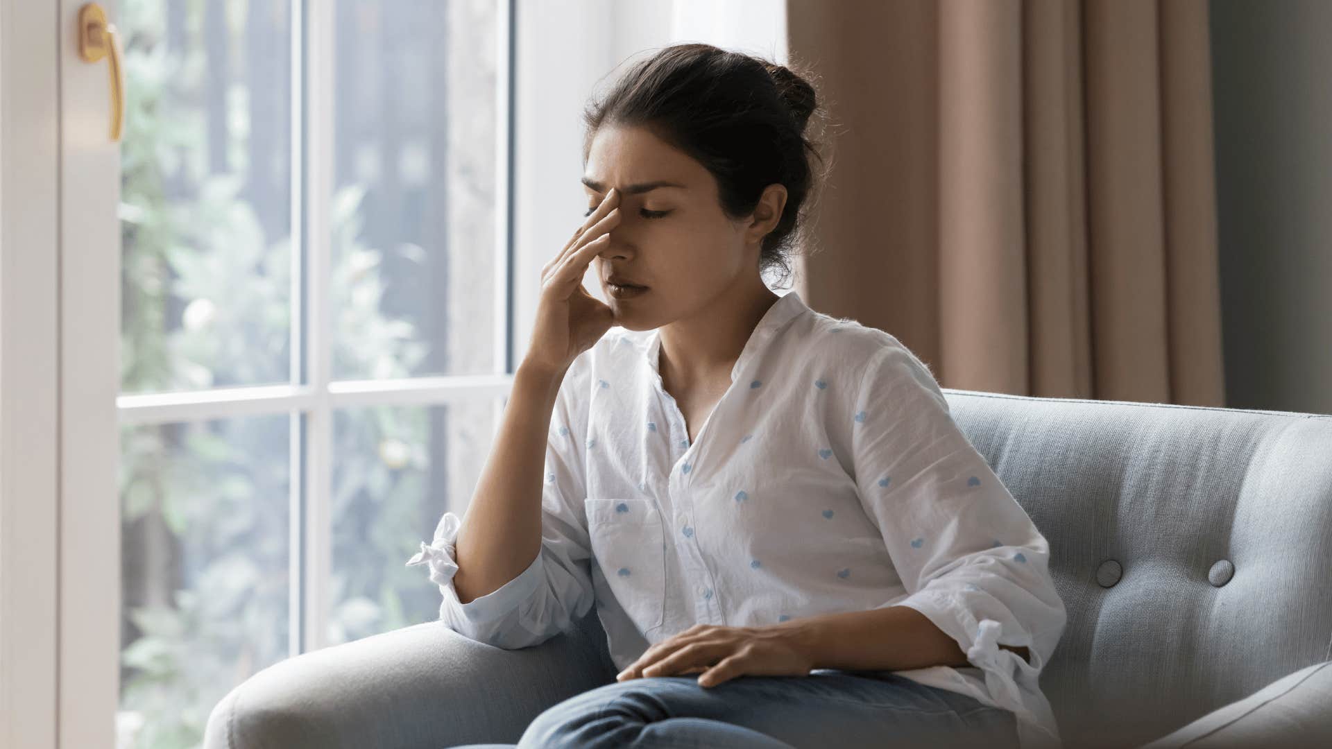 woman sad looking out window