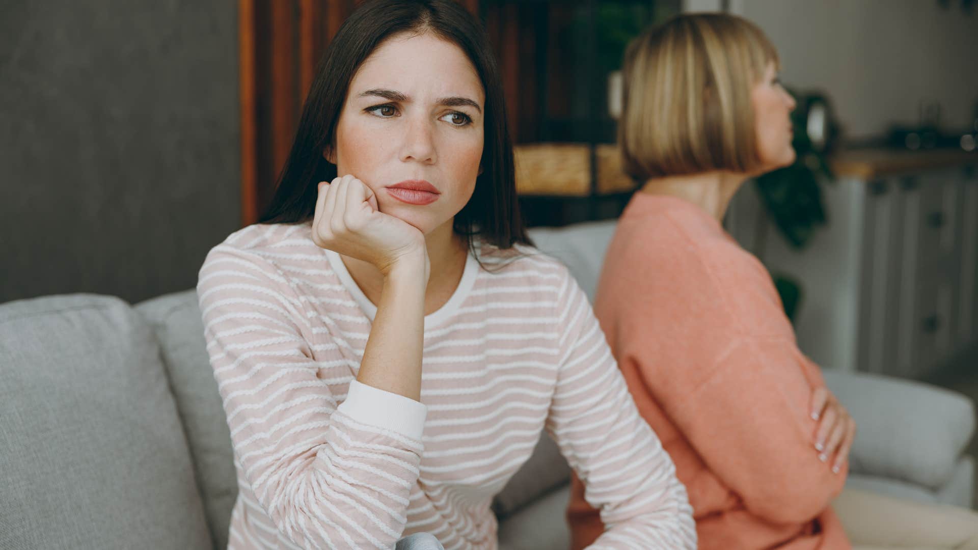 Adult woman turned away from her upset mother.