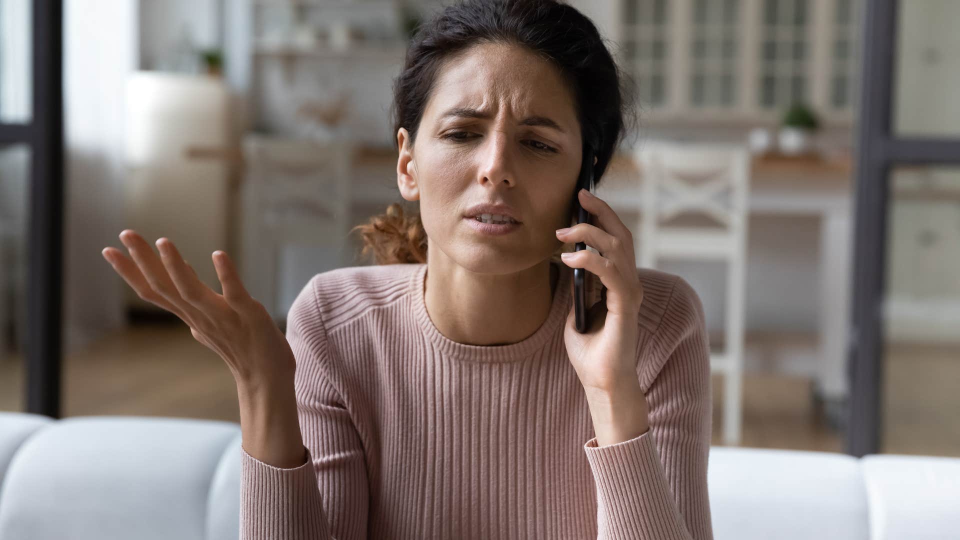 Woman looking annoyed talking on the phone