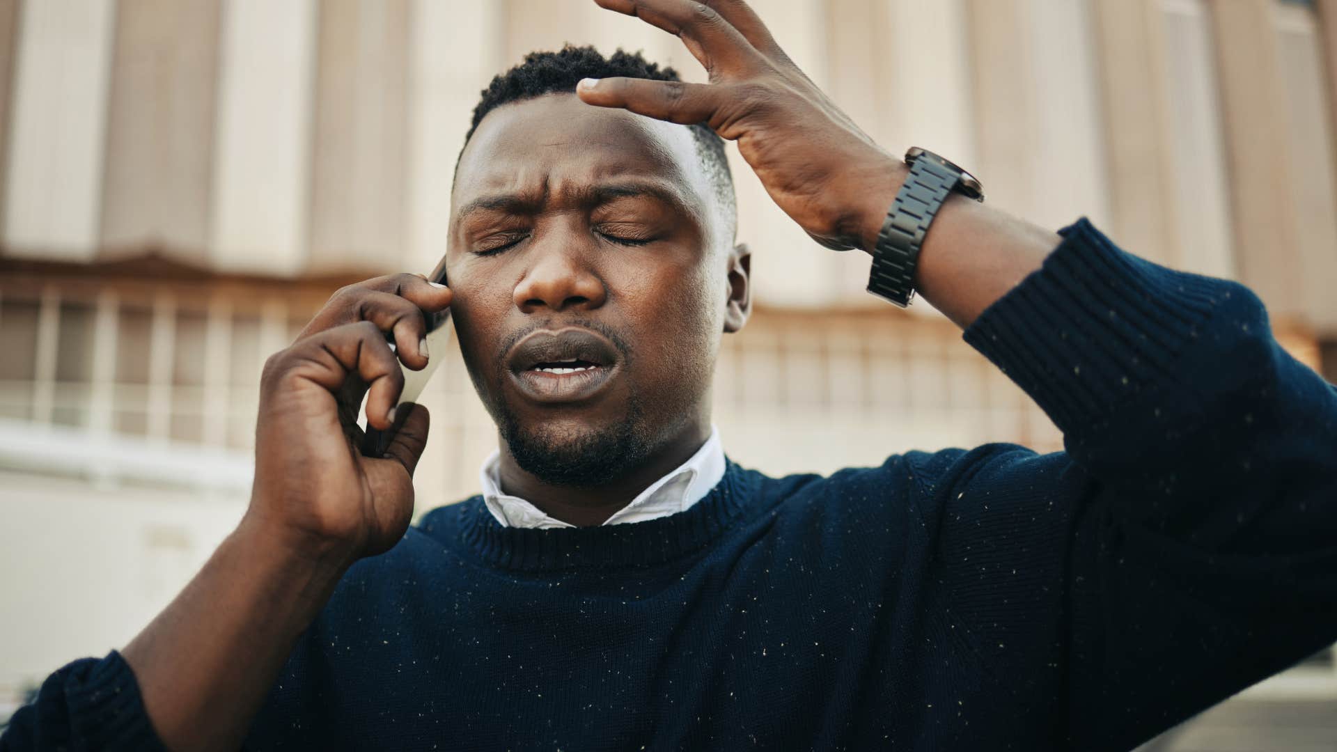 Man looking annoyed while talking on the phone