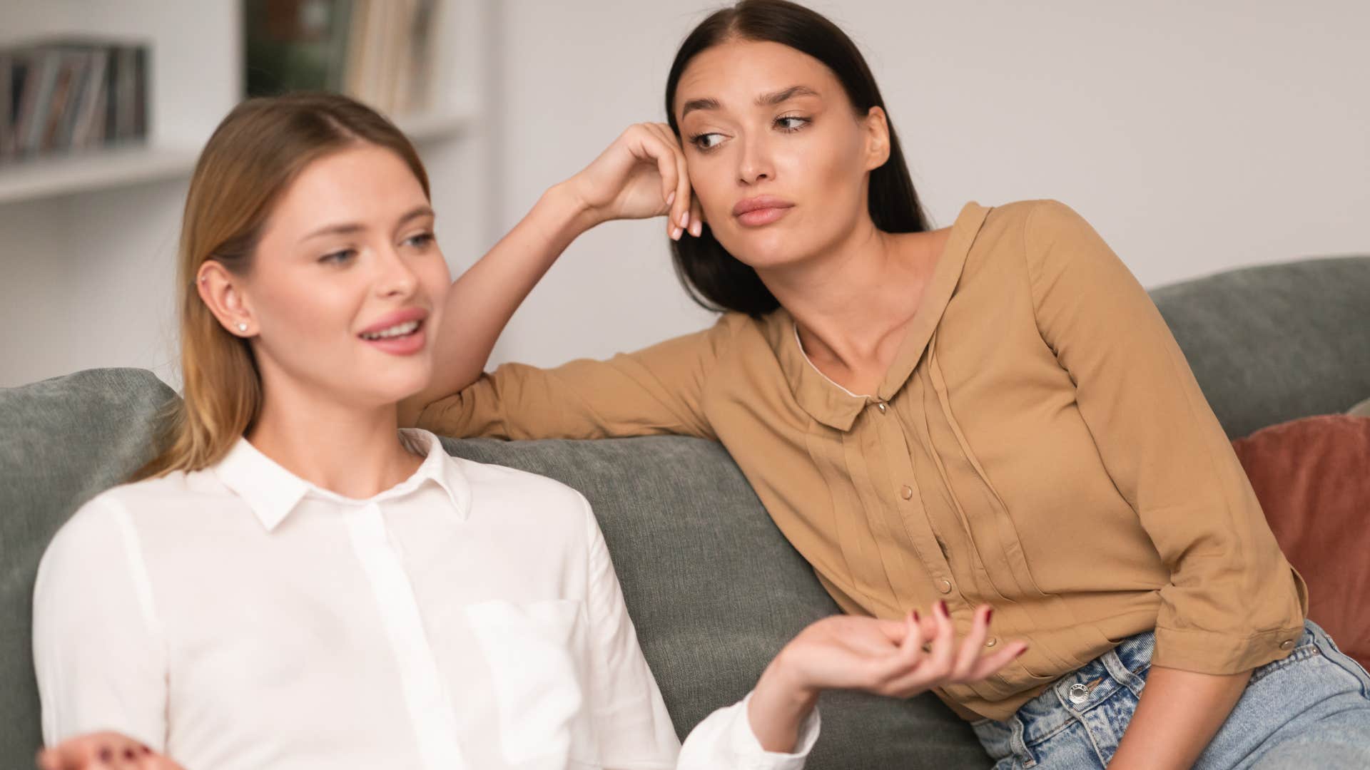 Woman looking annoyed next to her friend