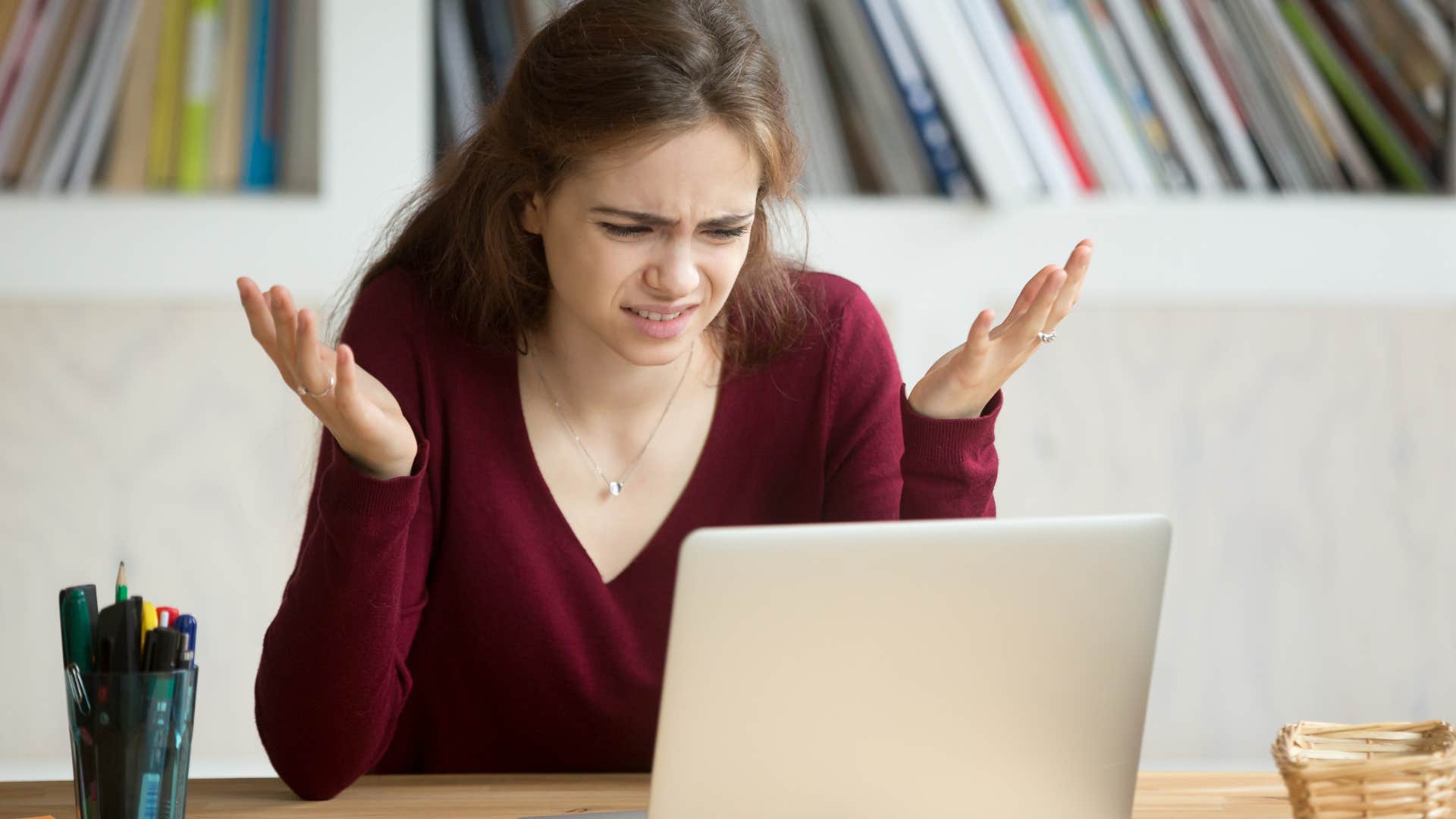 Woman looking annoyed staring at her laptop