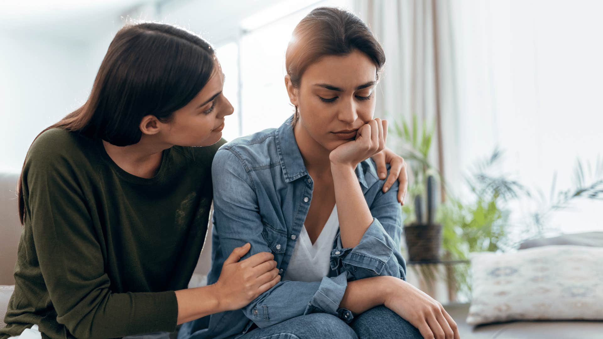 woman comforting another woman