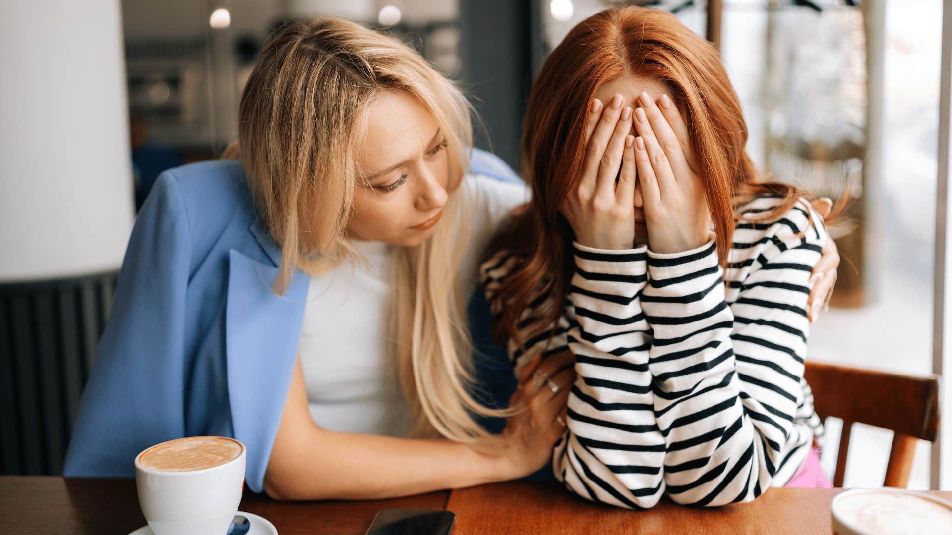 women comforting a sad friend