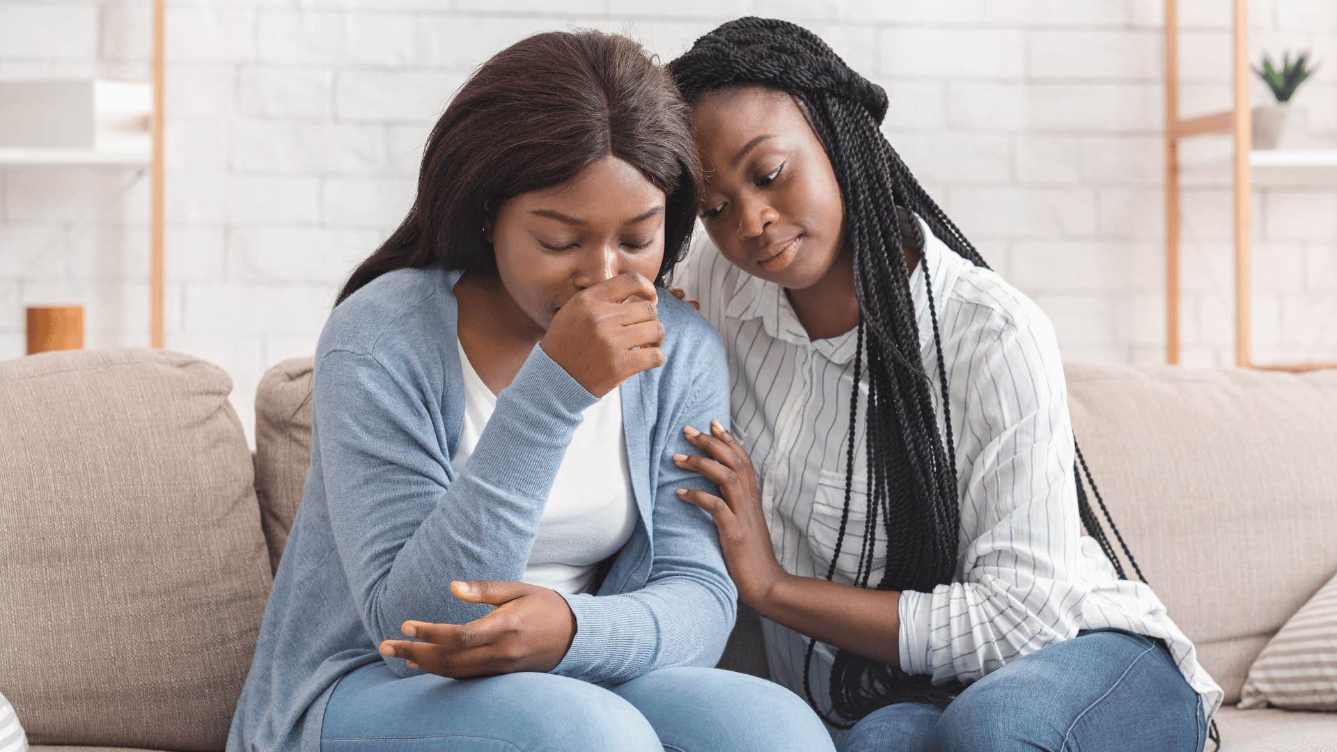 woman comforting another woman