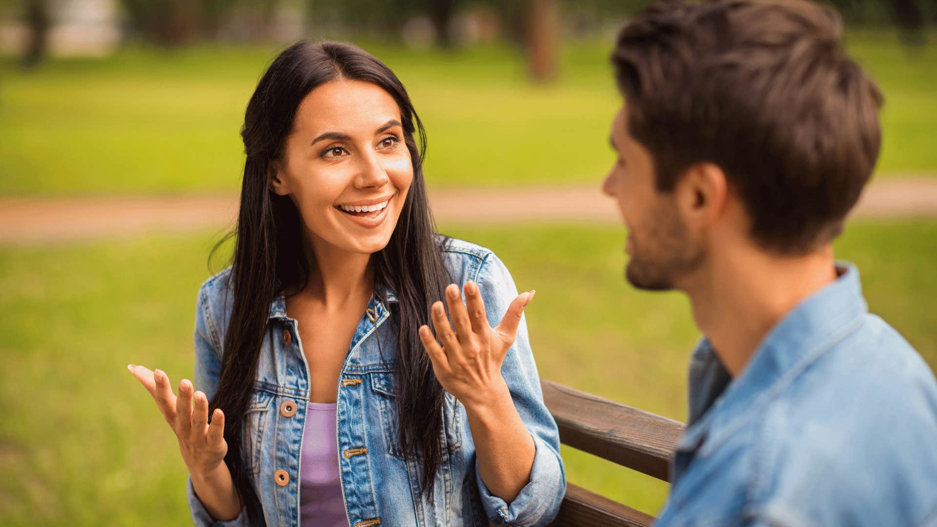 man and woman chatting on a bench