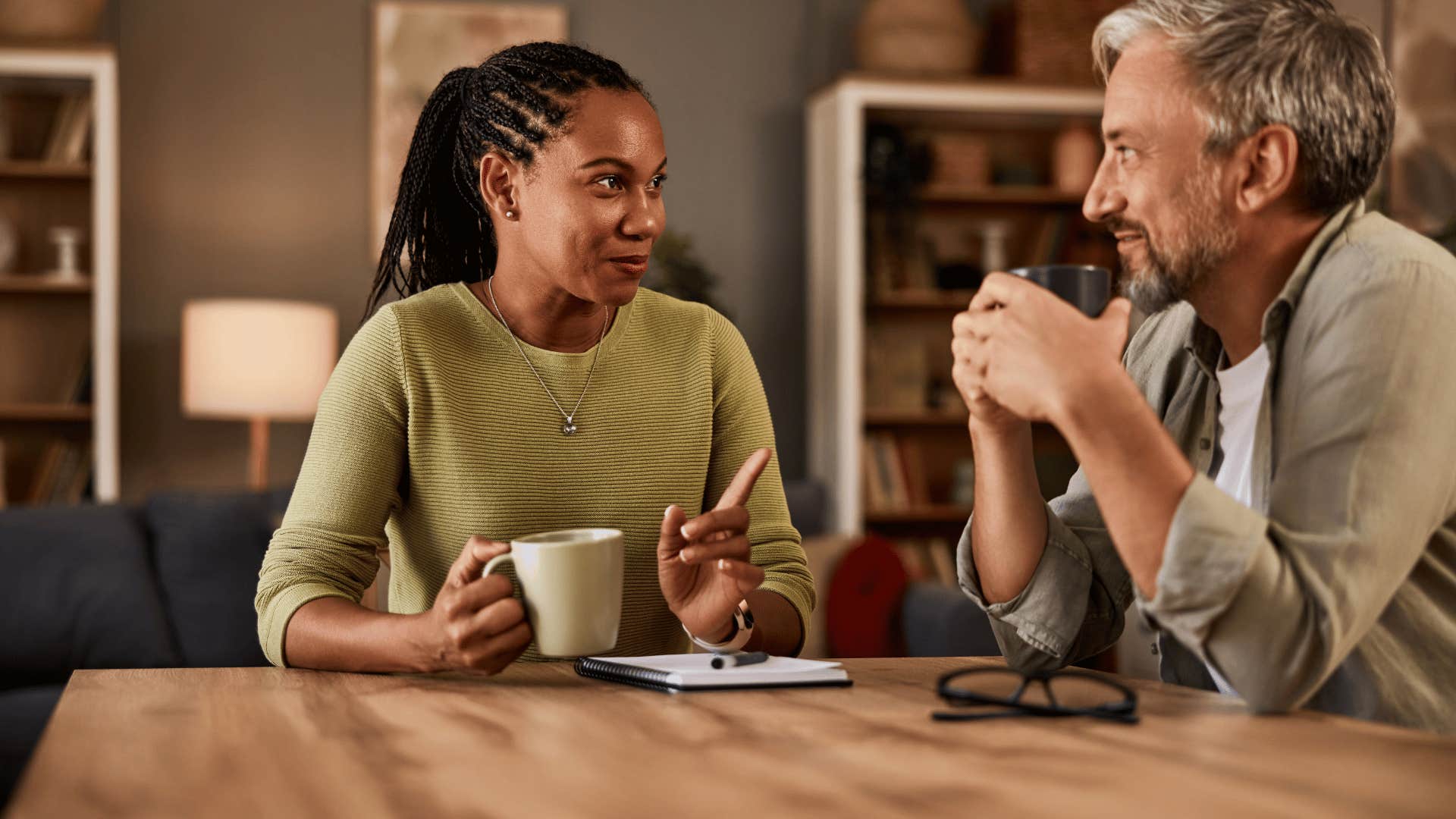 two people talking while drinking coffee