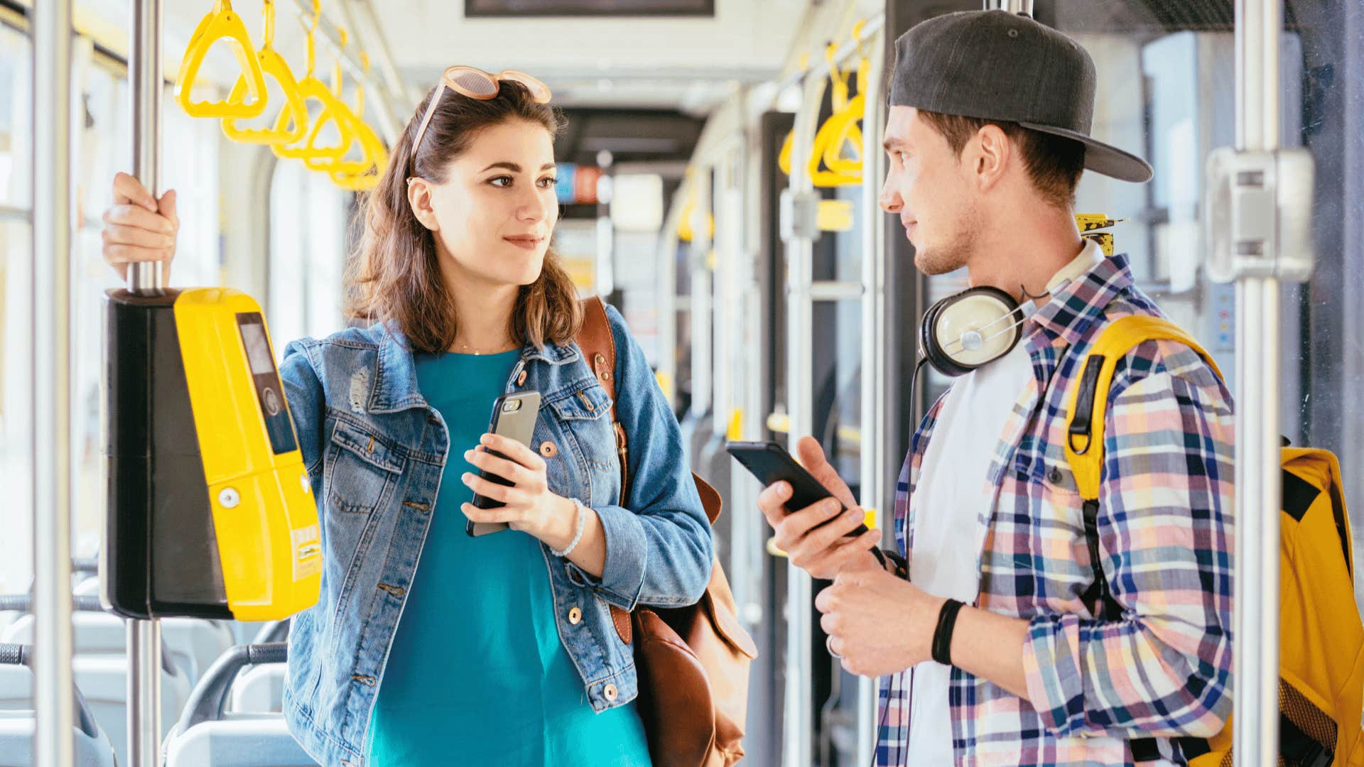 man and woman talking on train