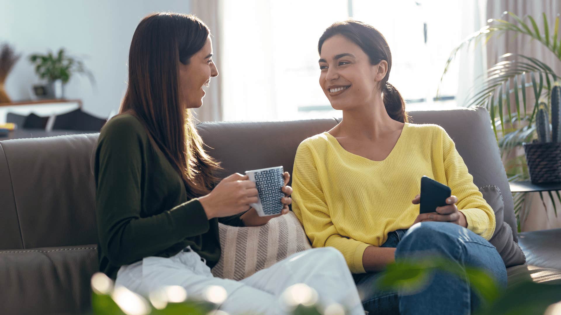 two women chatting while drinking coffee