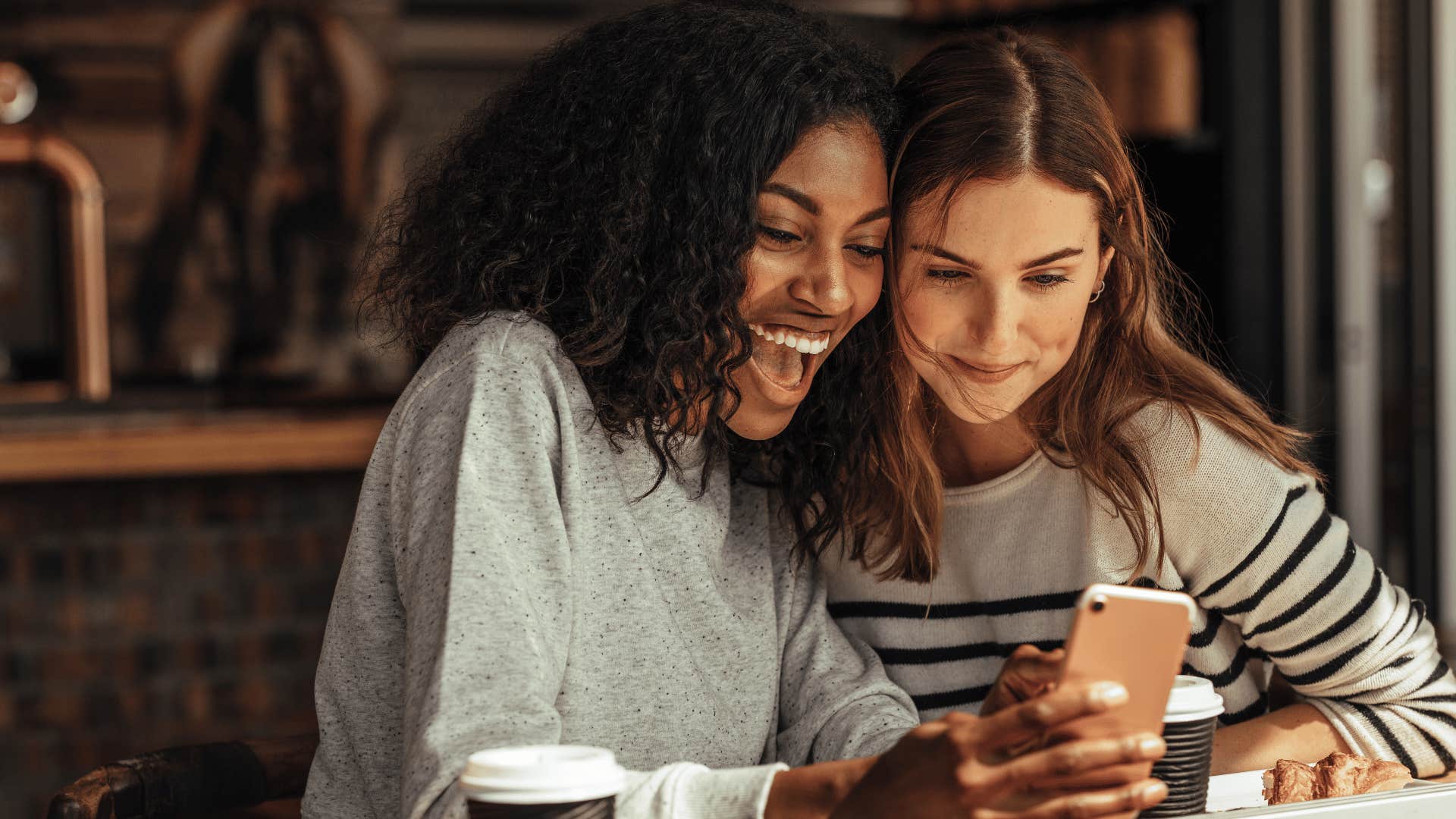 two friends looking at cell phone