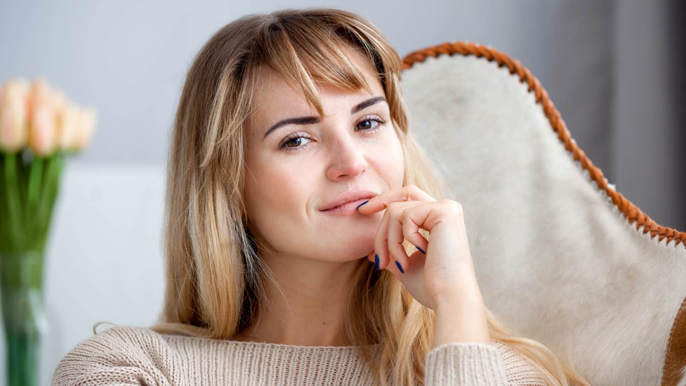 smirking brilliant woman sitting on a couch