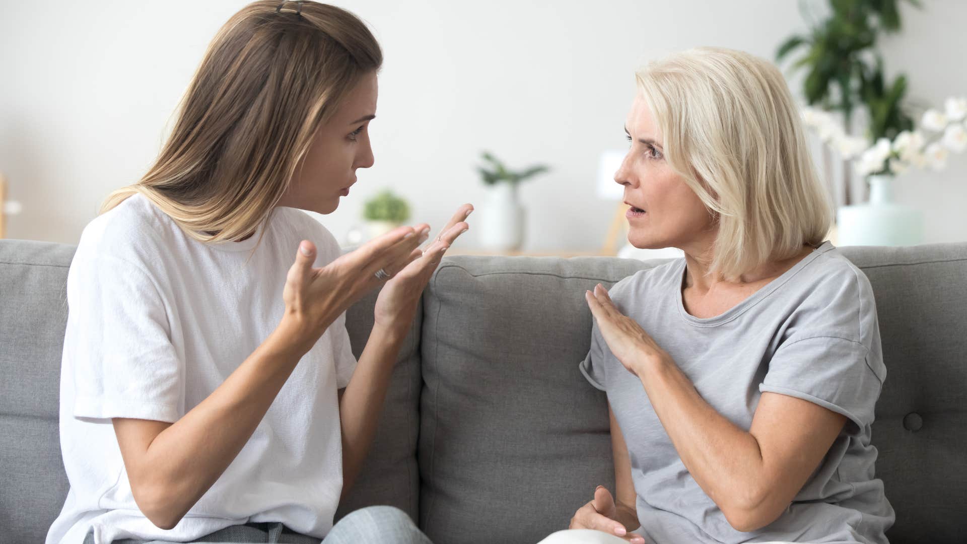 Woman arguing with her mother on the couch.