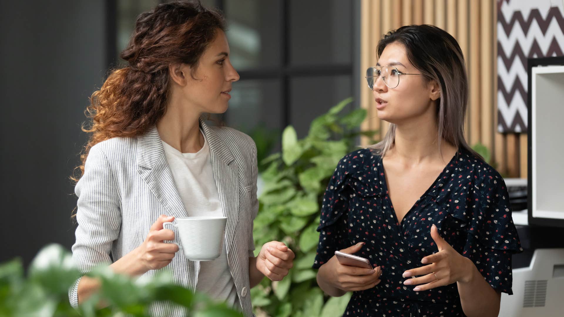 Two women talking to each other at work