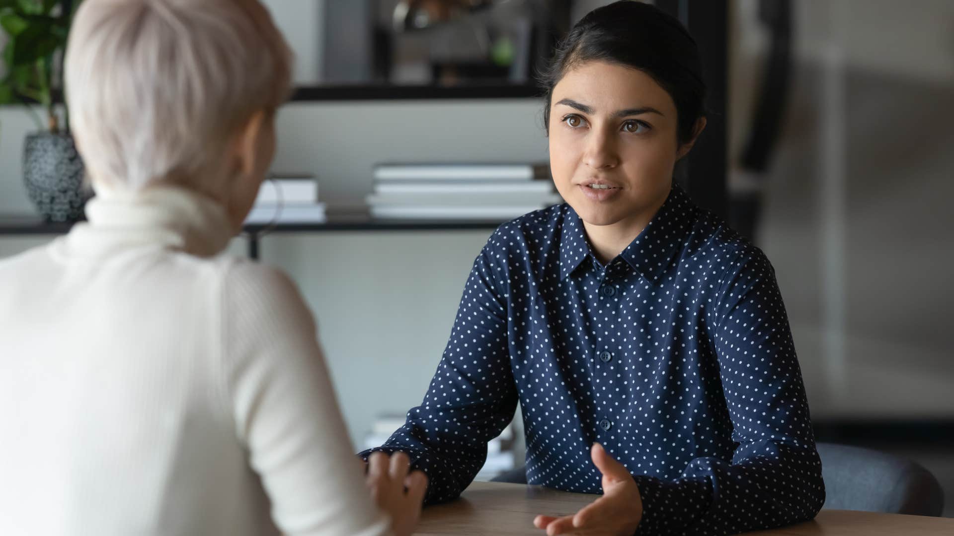 Professional woman talking to her boss at work