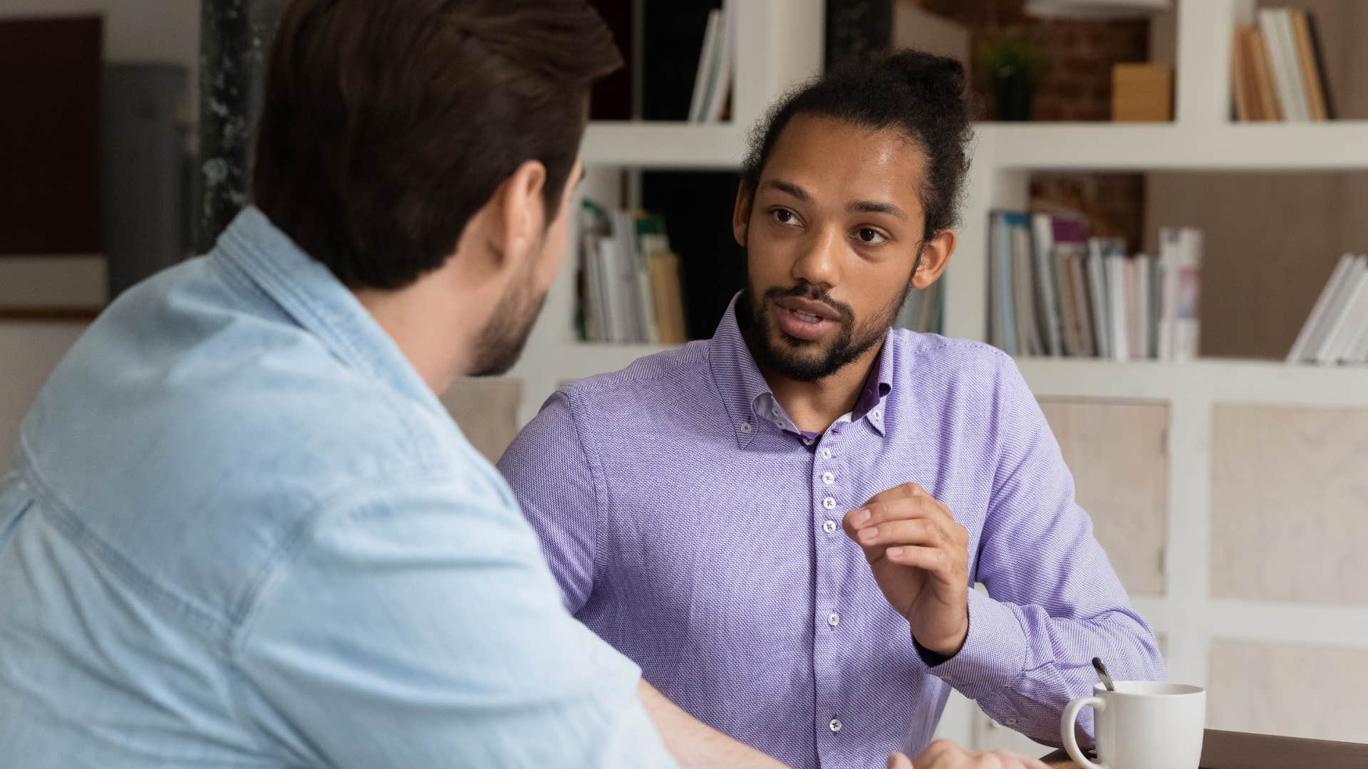 Man talking to his boss at work.