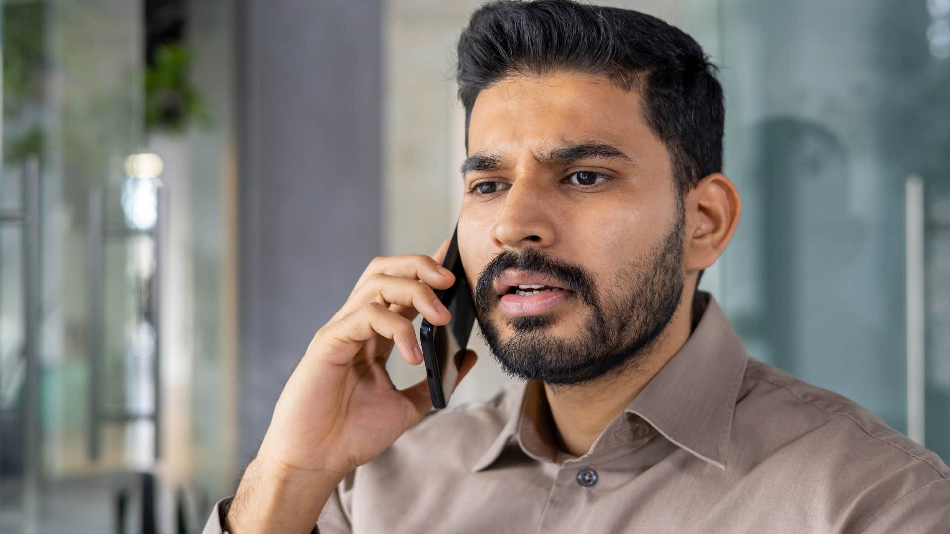 Man looking annoyed talking on the phone