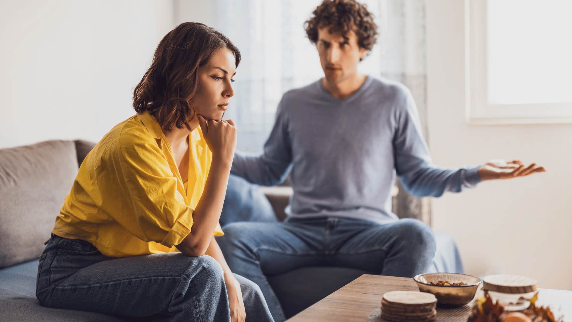 man arguing with woman while she ignores him and thinks 