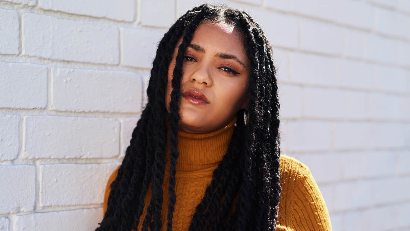 judgmental woman wearing yellow and braids