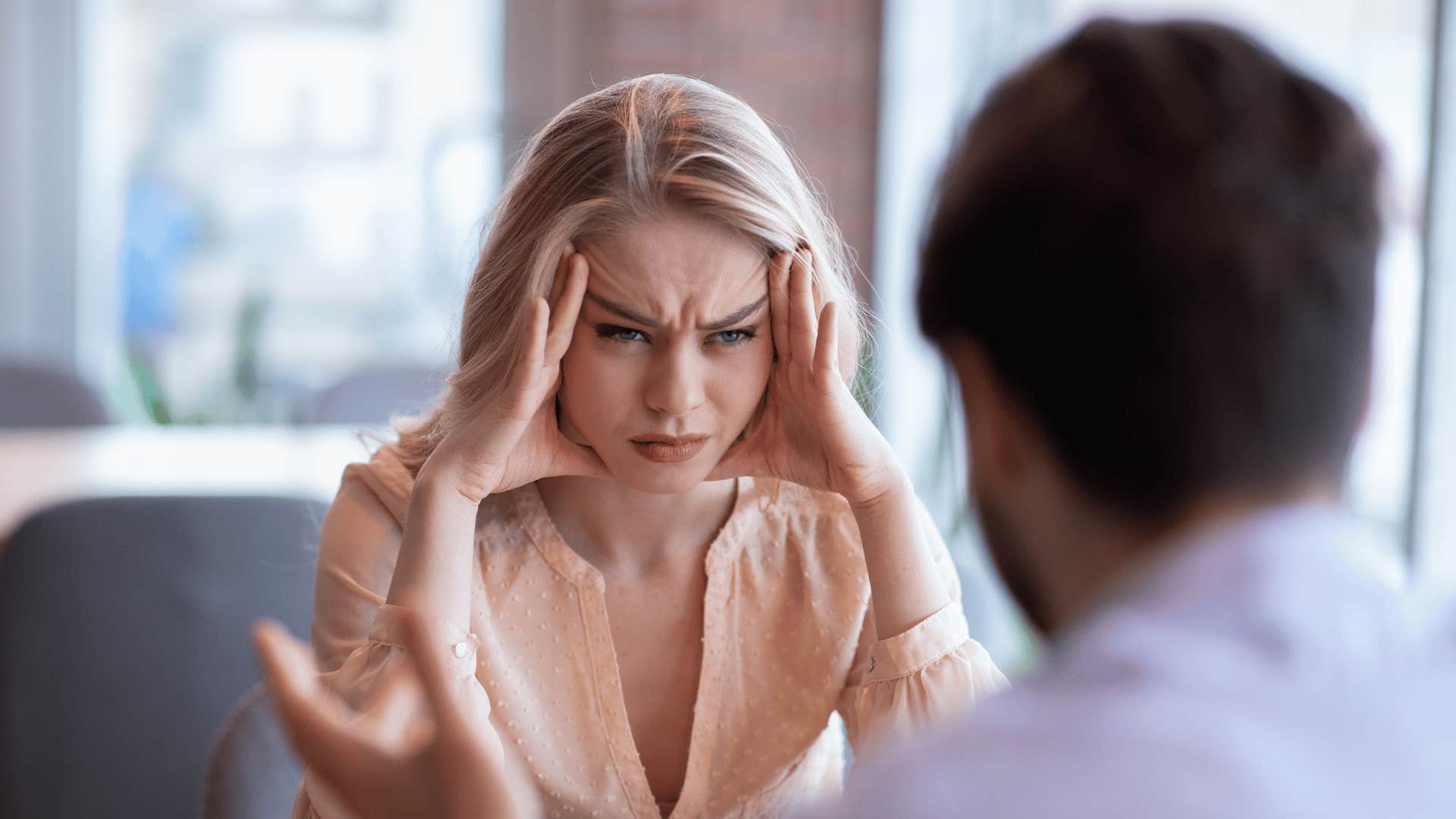 woman frustrated by a man talking