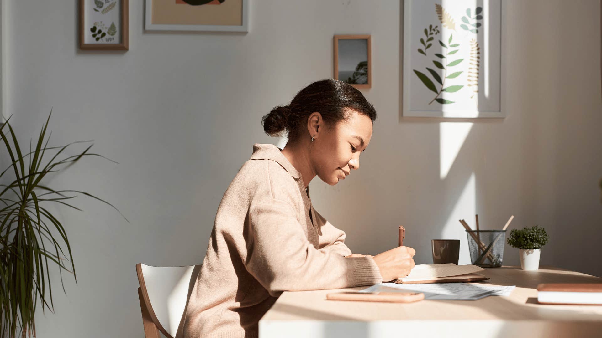 woman writing in journal 