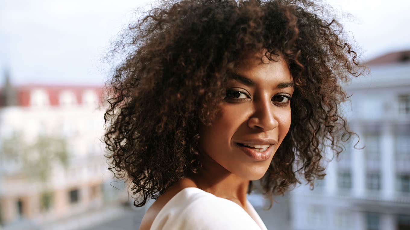 confident woman smiling standing outside