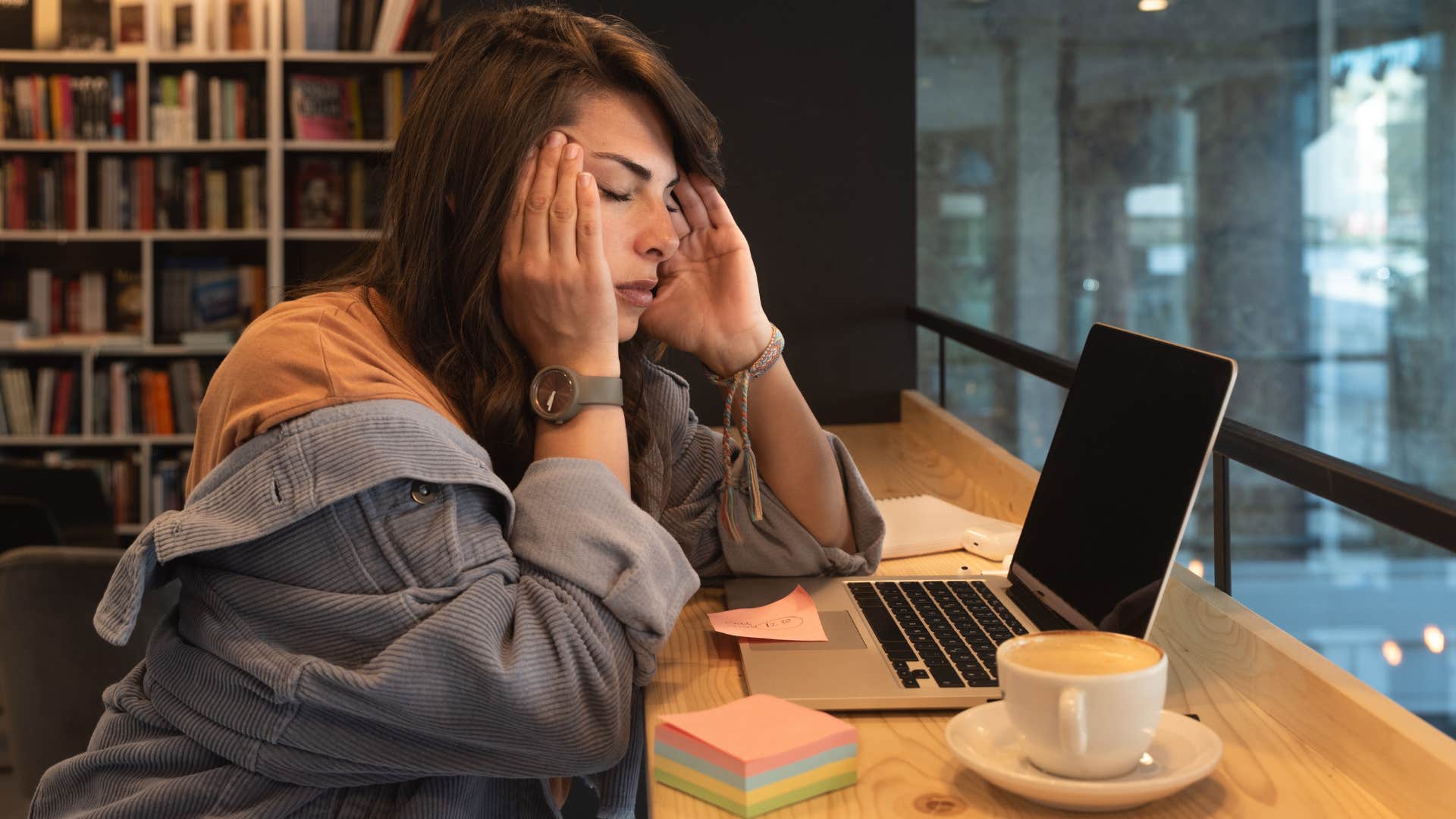 Woman looking frustrated staring at her laptop.