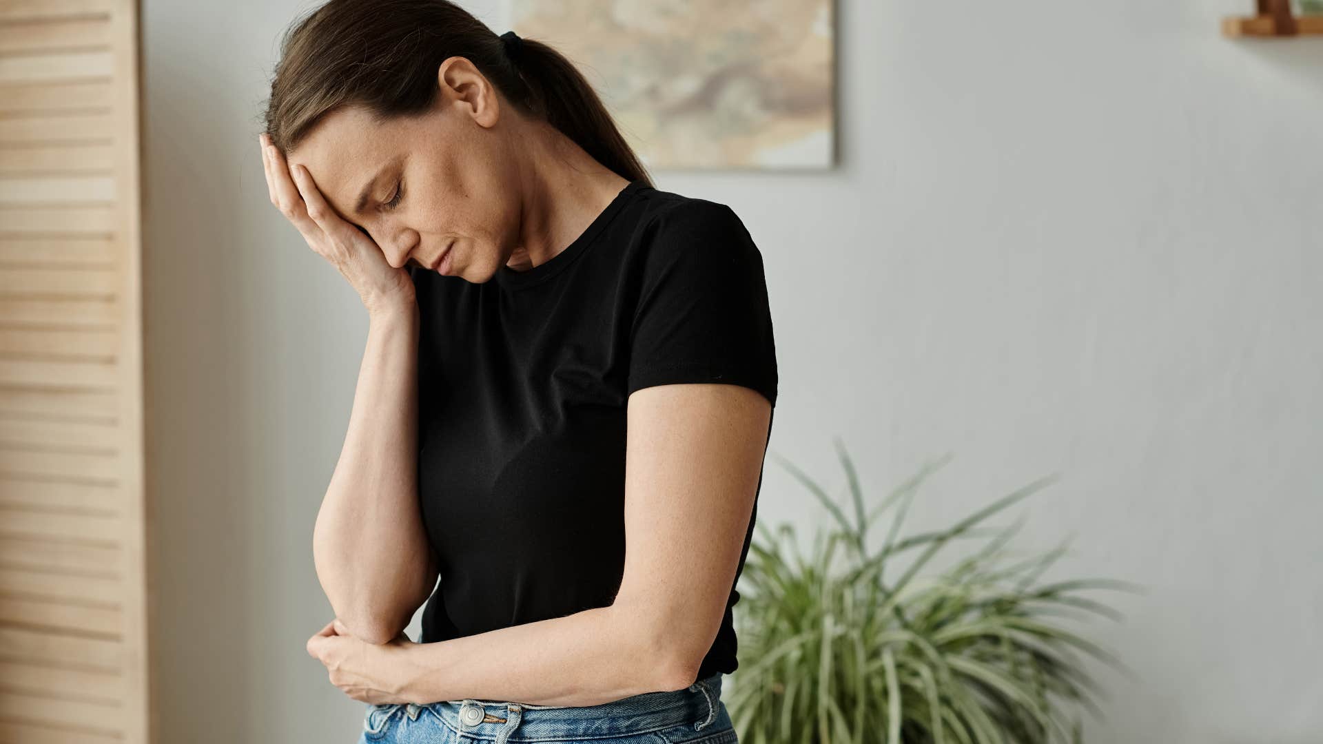 Woman looking annoyed and sad at home.