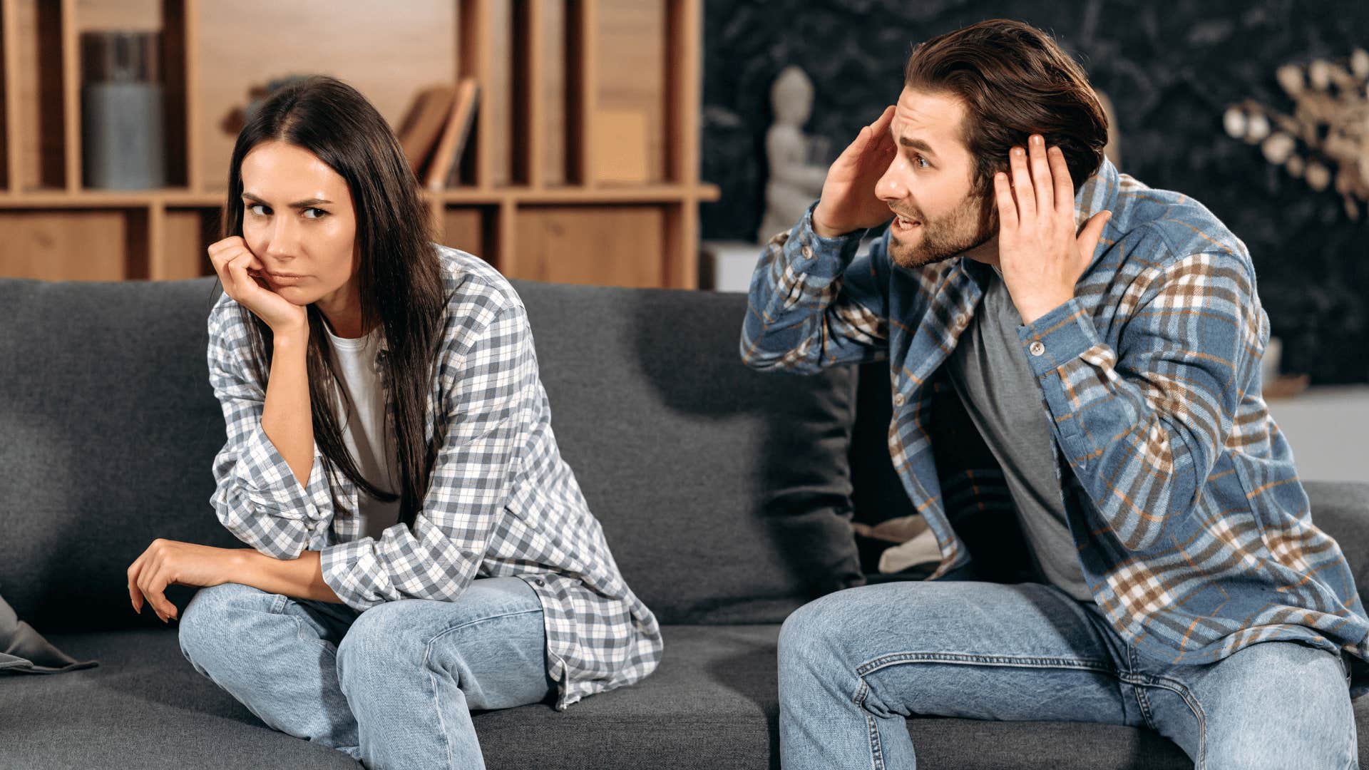 man complaining while woman looks away upset 