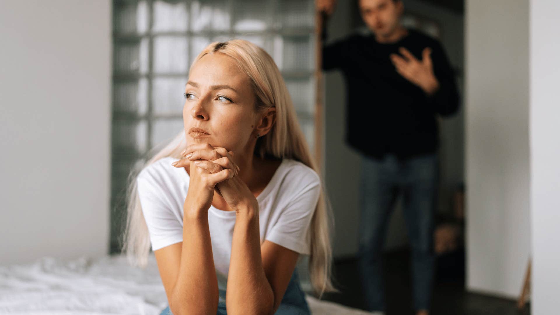 man arguing while woman ignores him 