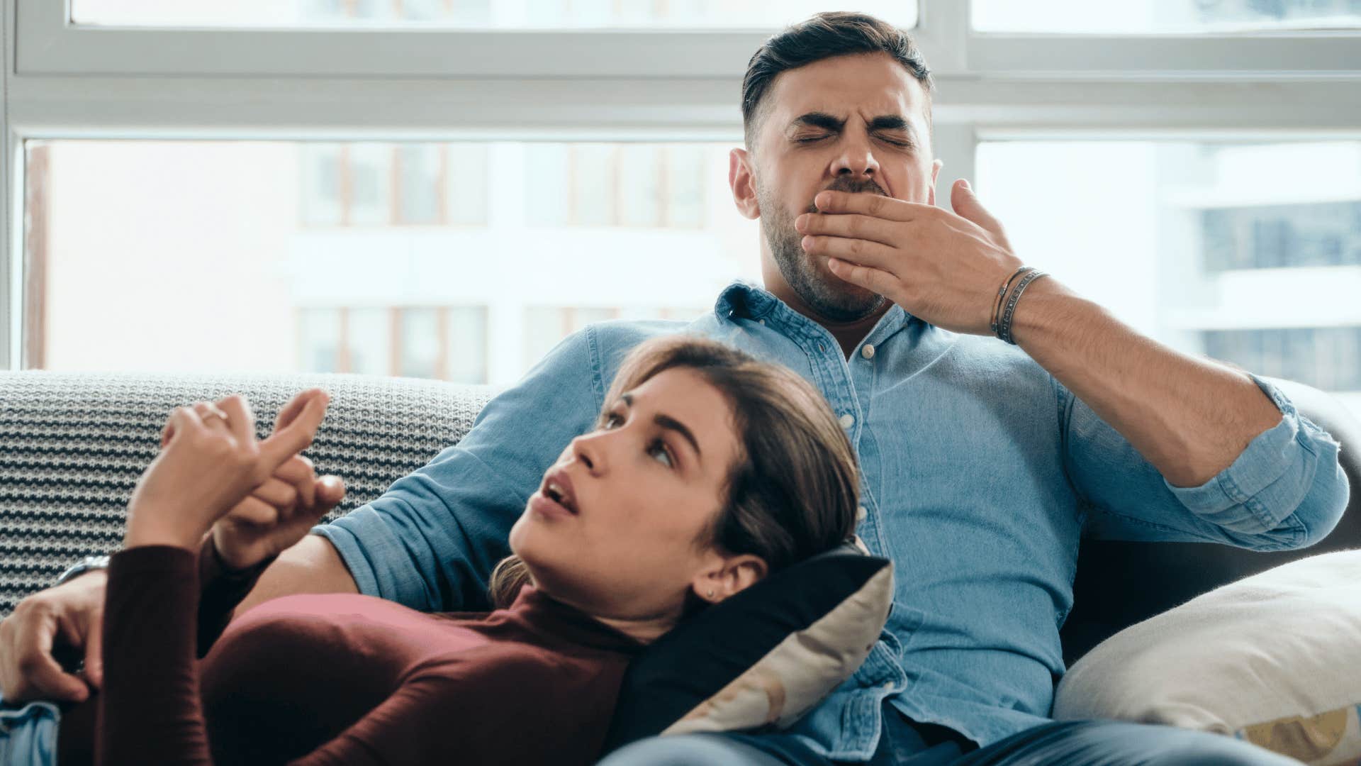 Man yawning when woman wants physical connection as excuse to stay together