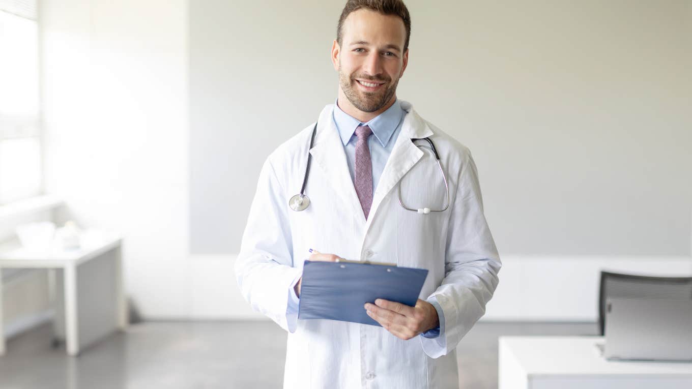 doctor holding chart standing in the middle of office